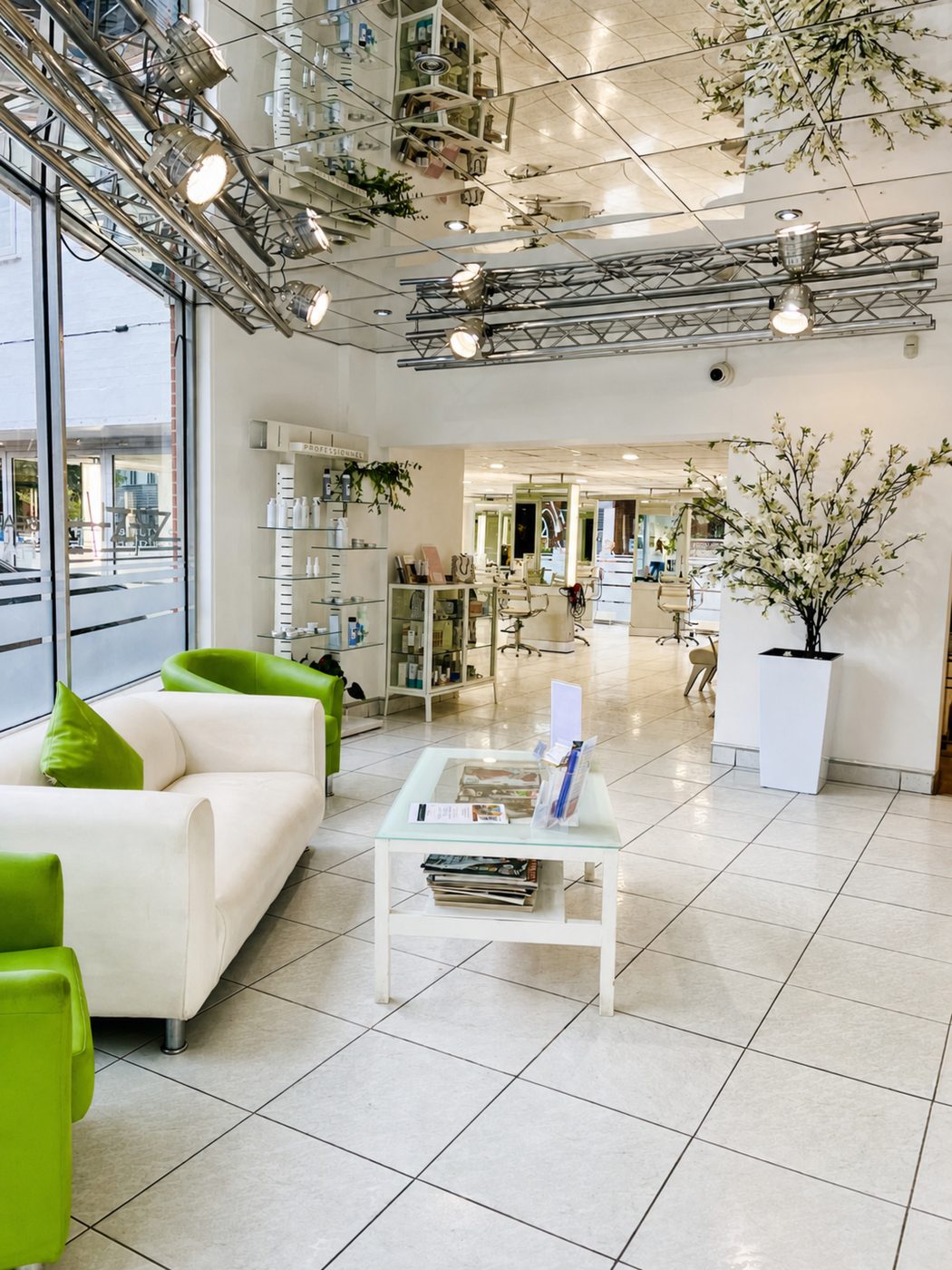 The bright, contemporary lounge and product display area inside Sash Hairdressing salon in Alsager, Cheshire